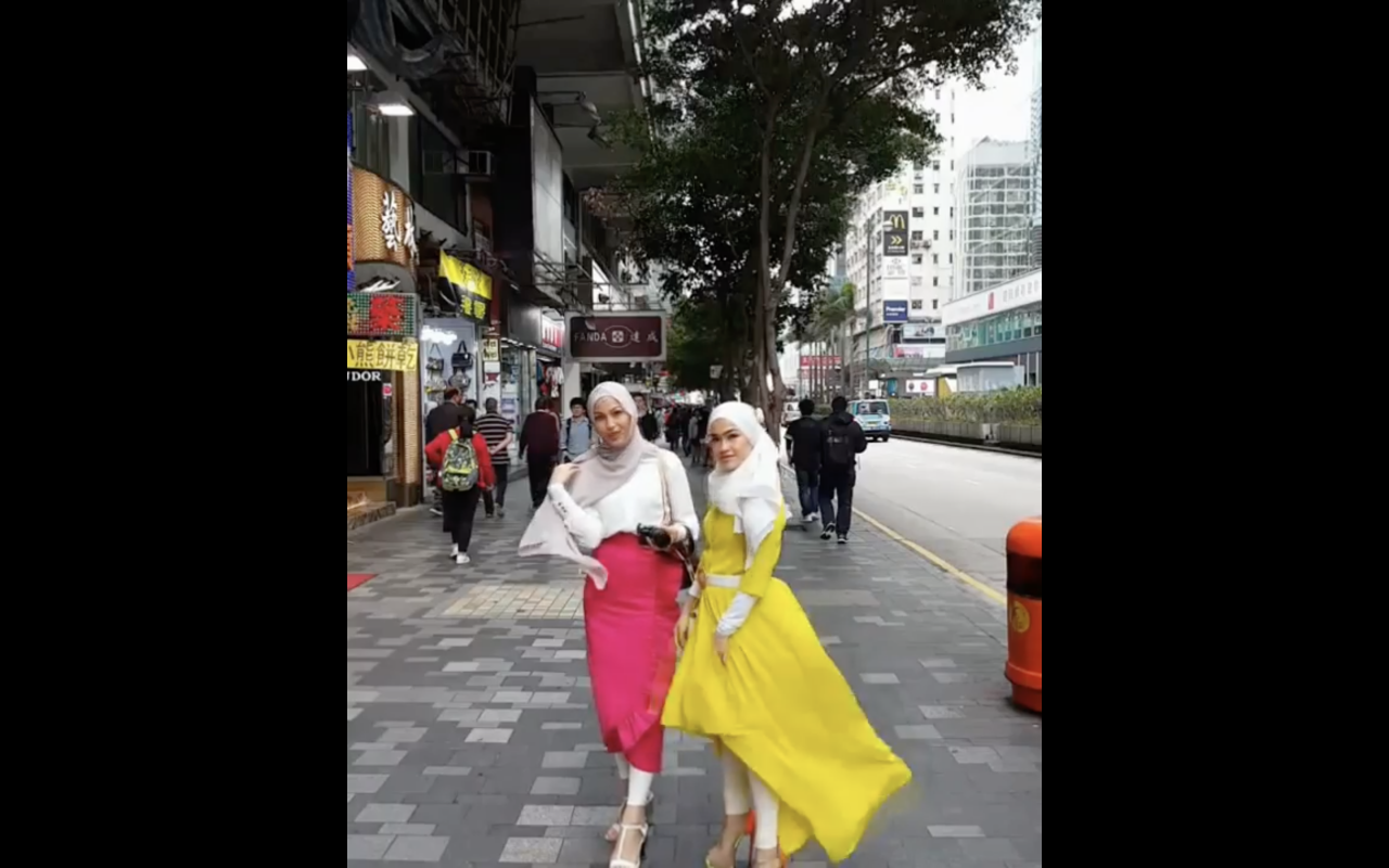 Elfira Loy and her sister, Ezlisa Loy on the street of Tsim Sha Tsui, a shopping district close to Victoria Harbour. – Screen grab