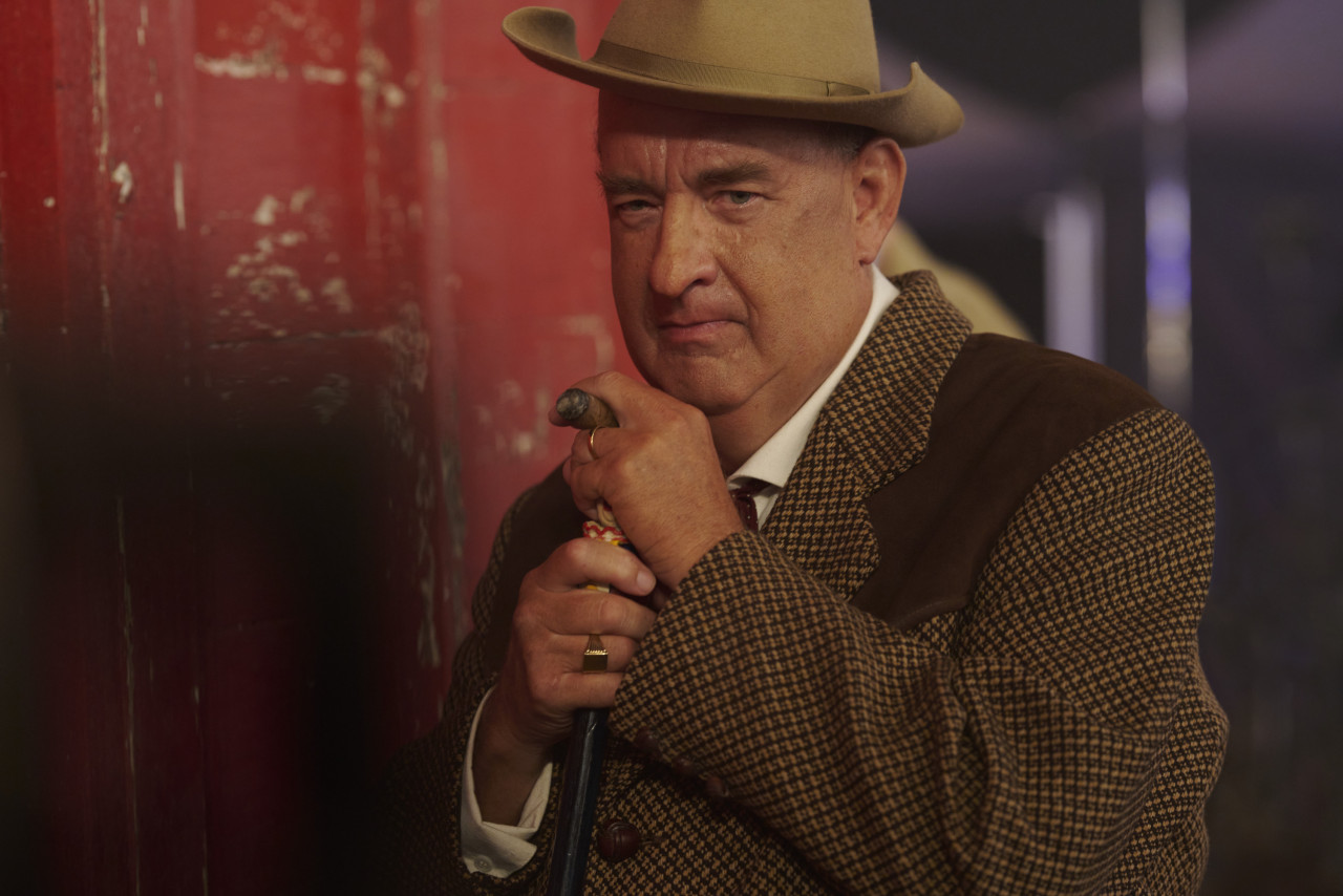 Yes, that’s Tom Hanks playing the manipulative and scheming Colonel Tom Parker. It’s not a bad performance, but it can lean heavy into the cartoonish. – Pic courtesy of Warner Bros