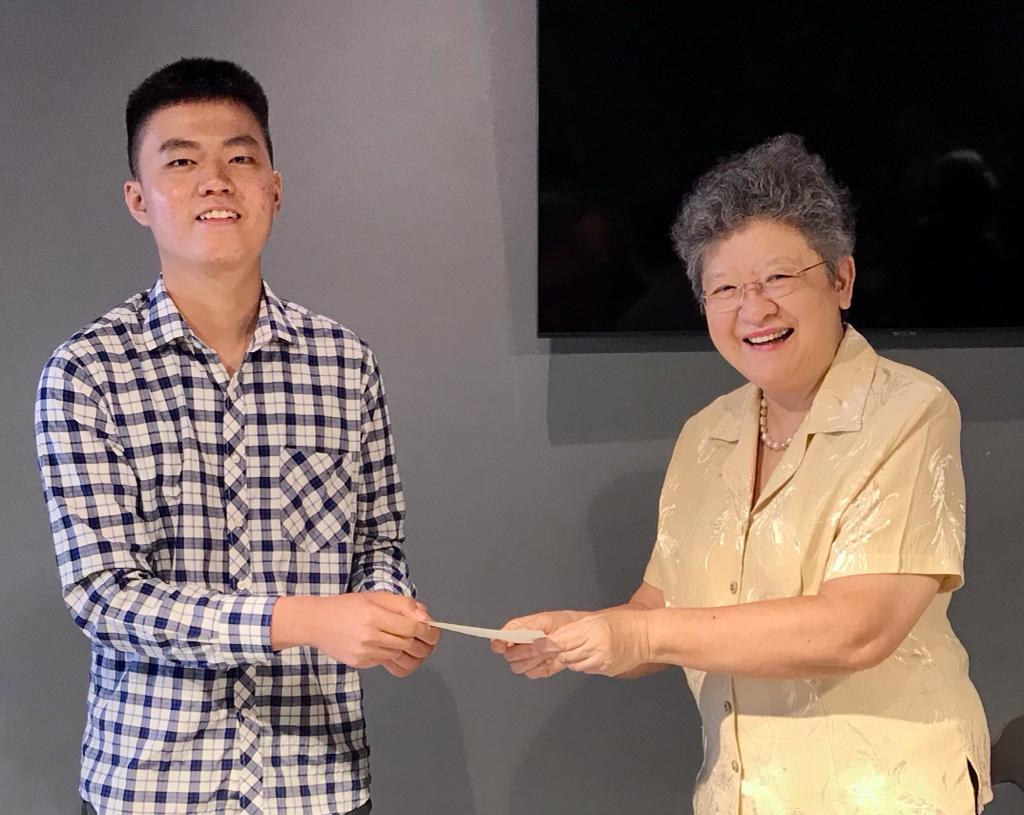 Moey (right) presenting scholarship funds to Elena Cooke Education Fund 2022 recipient Daniel Lee. – Pic courtesy of BBGS Alumni