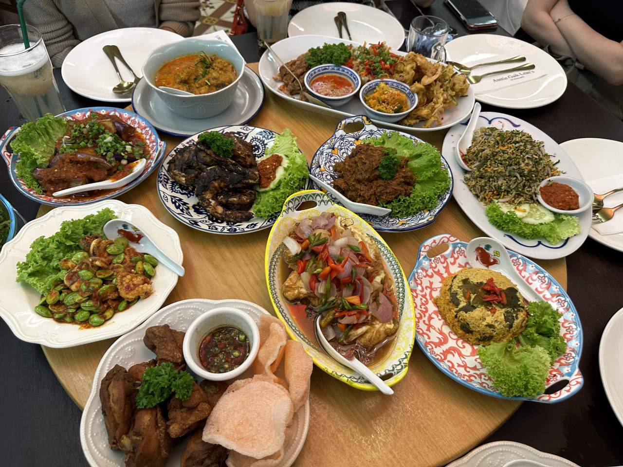 Almost the full spread at the restaurant, there were simply too many dishes to fit on the lazy susan. Among the dishes shown are Authentic Nyonya Curry Kapitan Chicken, Nyonya Inchi Kabin, Nyonya Beef Rendang, Otak Otak, Petai Octopus Sambal, Tamarind Prawns, and Nasi Ulam. – Haikal Fernandez pic
