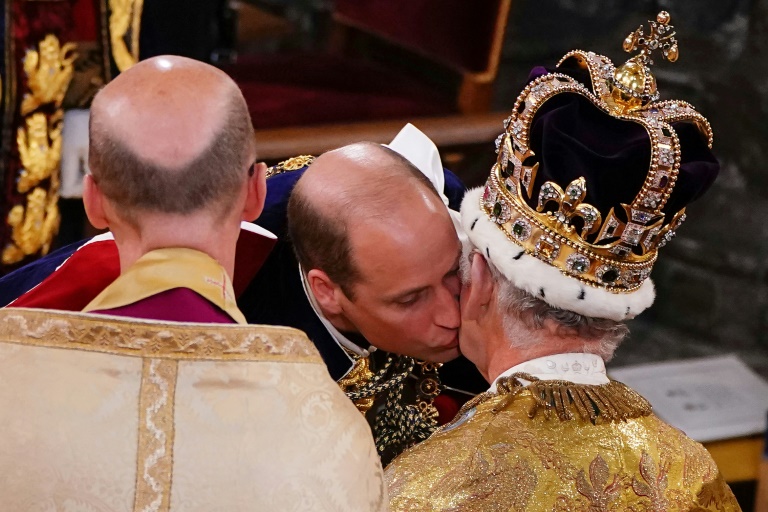 Charles's son Prince William pledged his allegiance – and gave his father a kiss. – AFP pic