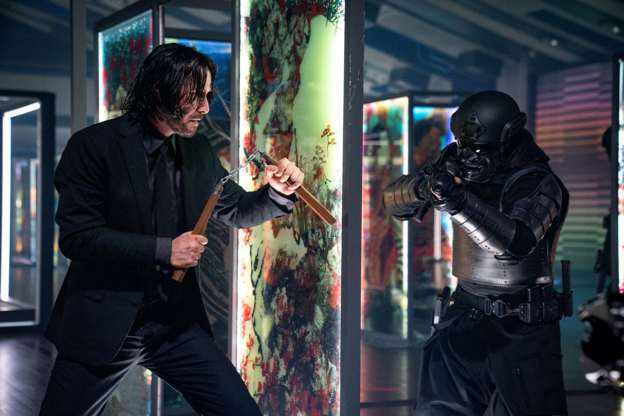 On one side is a guy in full armour and an automatic weapon, on the other side is a man armed with a couple of short sticks. One of them isn’t making it out alive. – Pic courtesy of Warner Bros