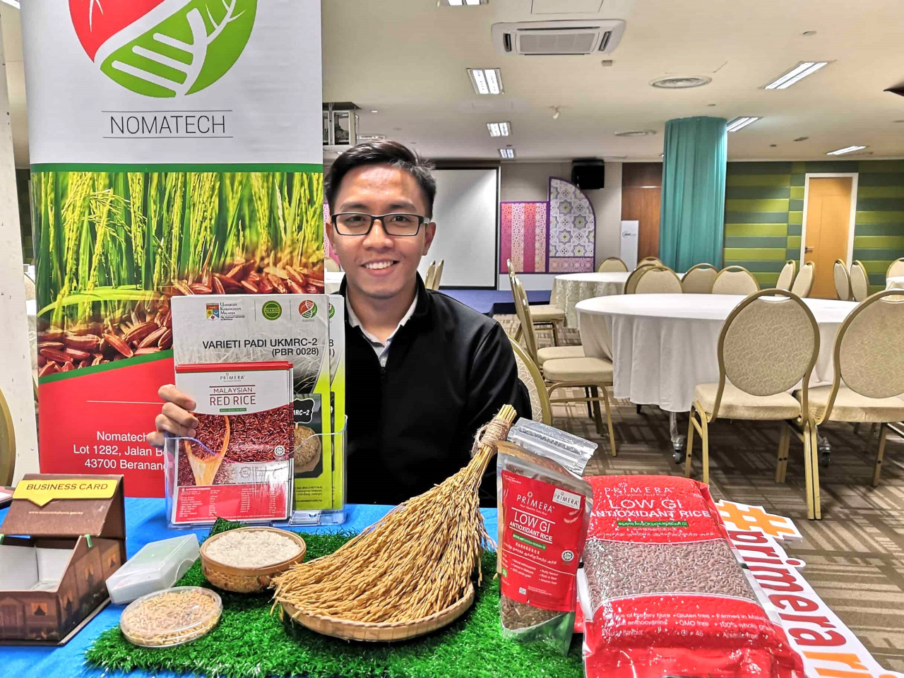 A staff from Nomatech poses with a packet of the Primera Red Rice now on sale. – Pic courtesy of Somatech
