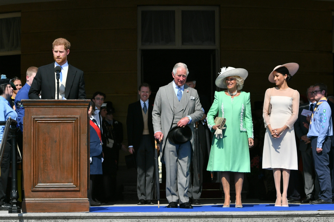 King Charles III and his wife Camilla, (second from right), talk with Meghan, Duchess of Sussex (right), as her husband, Prince Harry, Duke of Sussex, speaks during the Prince of Wales's 70th Birthday Garden Party at Buckingham Palace in London on May 22, 2018. – AFP file pic