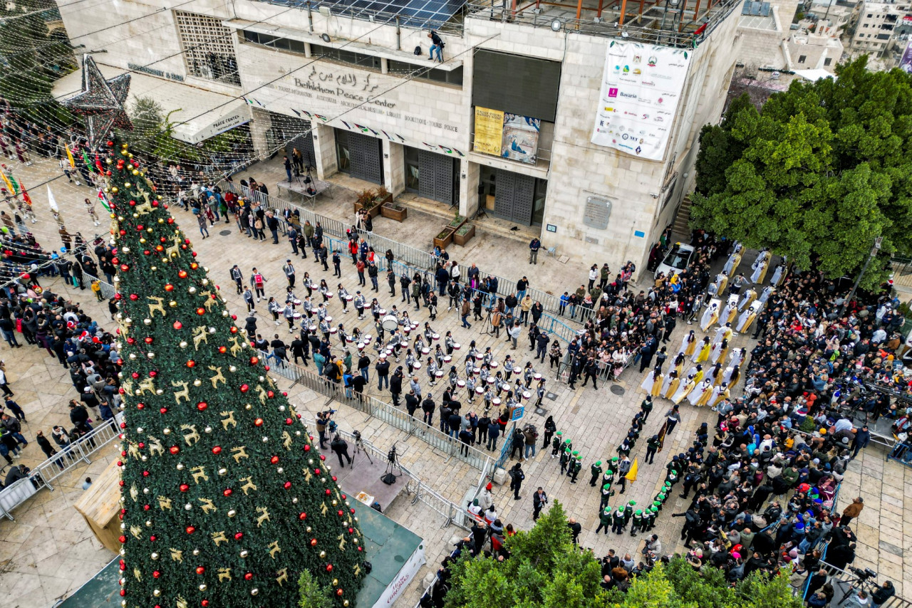 This aerial view shows members of the scouting movement marching during Christmas eve celebrations at the Manger Square outside the Church of the Nativity in the biblical city of Bethlehem in the occupied West Bank on Christmas eve on December 24, 2022. – AFP pic