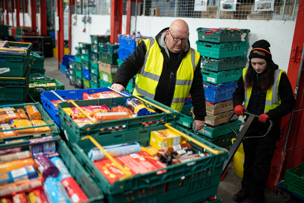 Workers at The Halo Centre, the central distribution point for donated items to be distributed to the Coventry Foodbank network of 14 sites across the city, collates food items into parcels that will be provided to people with a foodbank voucher, in Coventry, central England on January 23, 2023. – AFP pic