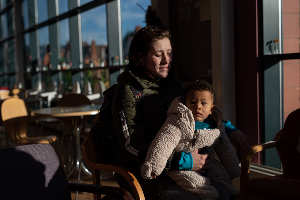 customer of the Coventry Foodbank centre in Queens Road Baptist Church sits with her one year-old son before collecting her food parcel, in Coventry, central England on January 23, 2023. – AFP pic