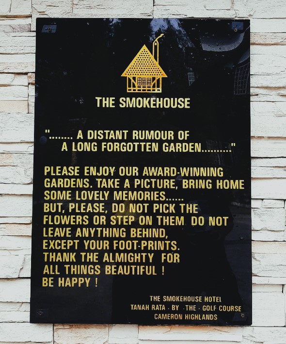The hotel's friendly reminder to patrons to take in the beautiful flowers in its English-styled, well-manicured gardens. – Pic courtesy of Ye Olde Smokehouse