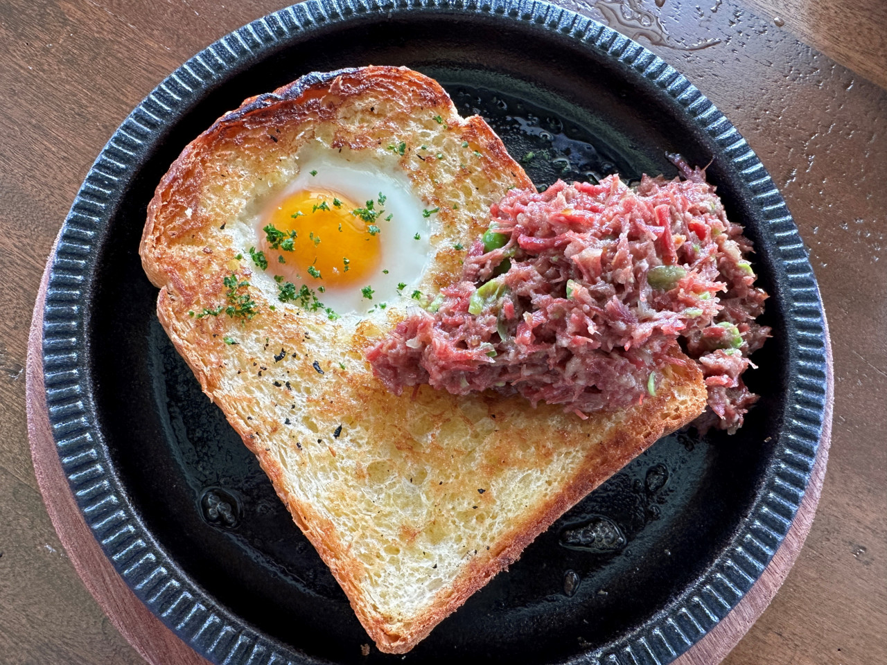With the corned beef salted for an extended period of time and a well toasted and fluffy brioche toast, the Corned Beef Egg in a Hole is a hearty breakfast dish. – Haikal Fernandez pic