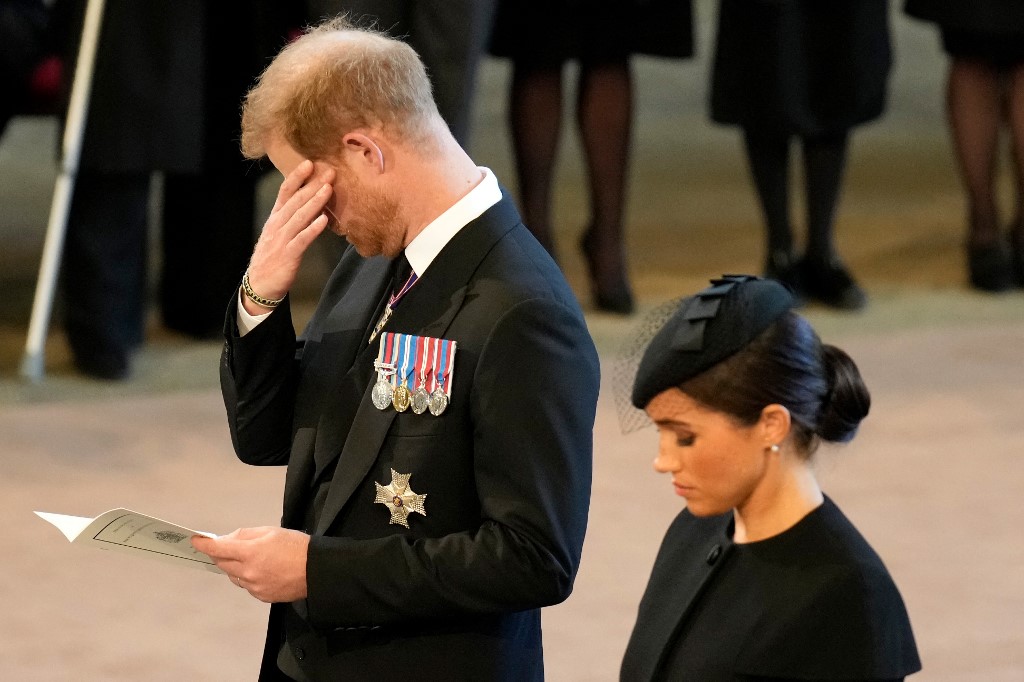 Britain's Prince Harry, Duke of Sussex, wiping away a tear as he pays his respects with Meghan, Duchess of Sussex inside Westminster Hall, at the Palace of Westminster, where the coffin of Queen Elizabeth II, will Lie in State on a Catafalque, in London on September 14, 2022. – AFP pic