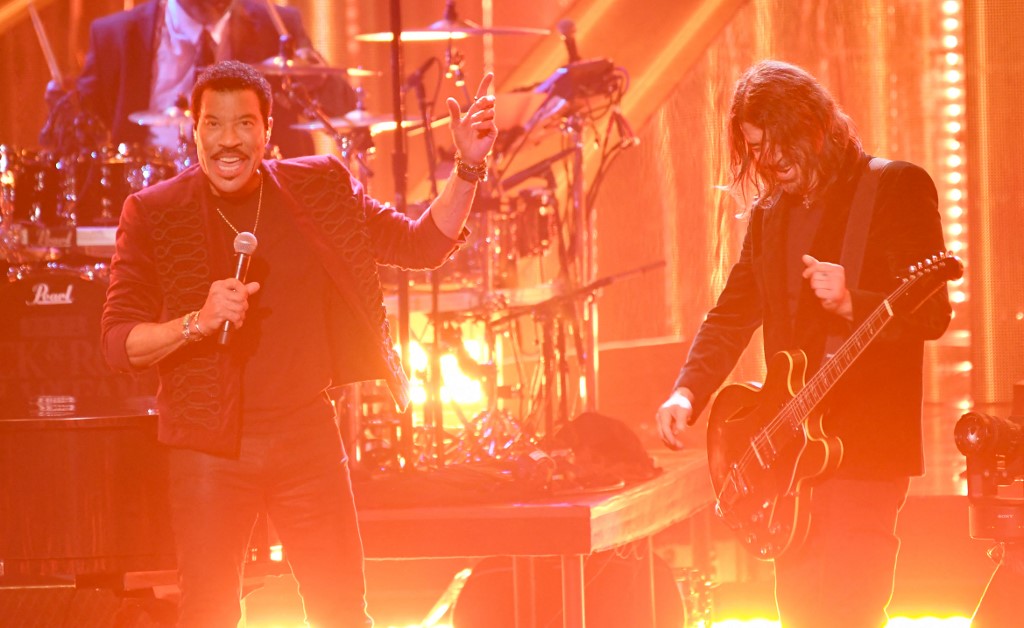 Inductee US singer-songwriter Lionel Richie performs on stage with US musician Dave Grohl (right). – AFP pic