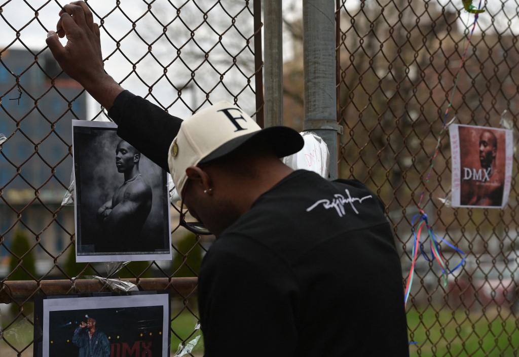 A man holds the fence at a makeshift memorial for hip-hop star DMX outside White Plains hospital in White Plains, New York on April 9, 2021. – AFP pic
