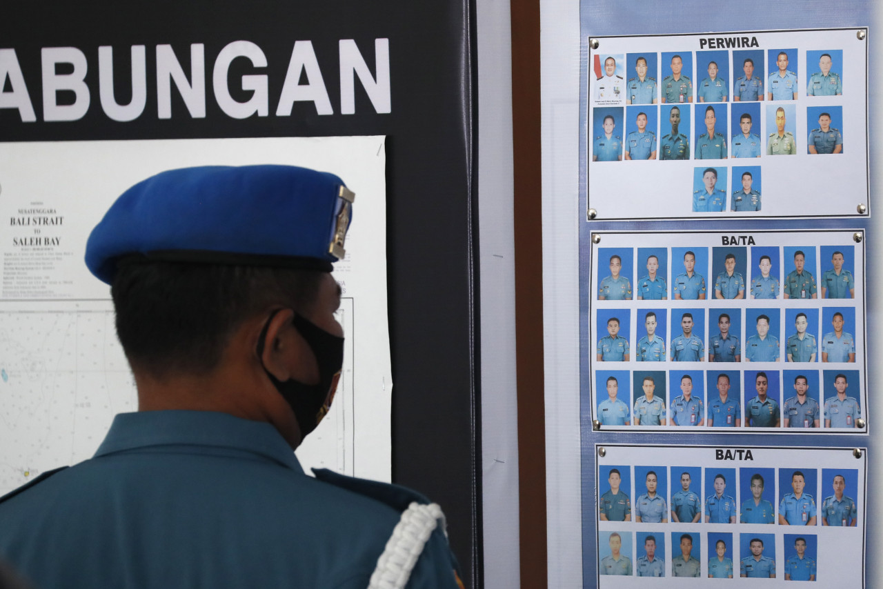 A military officer looks at photos of KRI Nanggala 402’s crew members, at a command centre in Bali. – EPA pic, April 23, 2021