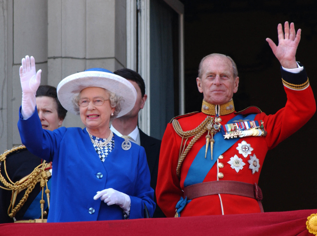 Queen Elizabeth II and Prince Philip wave from the balcony of Buckingham Palace in London during a flypast for the trooping of the colour on June 14, 2003. – AFP pic, April 9, 2021
