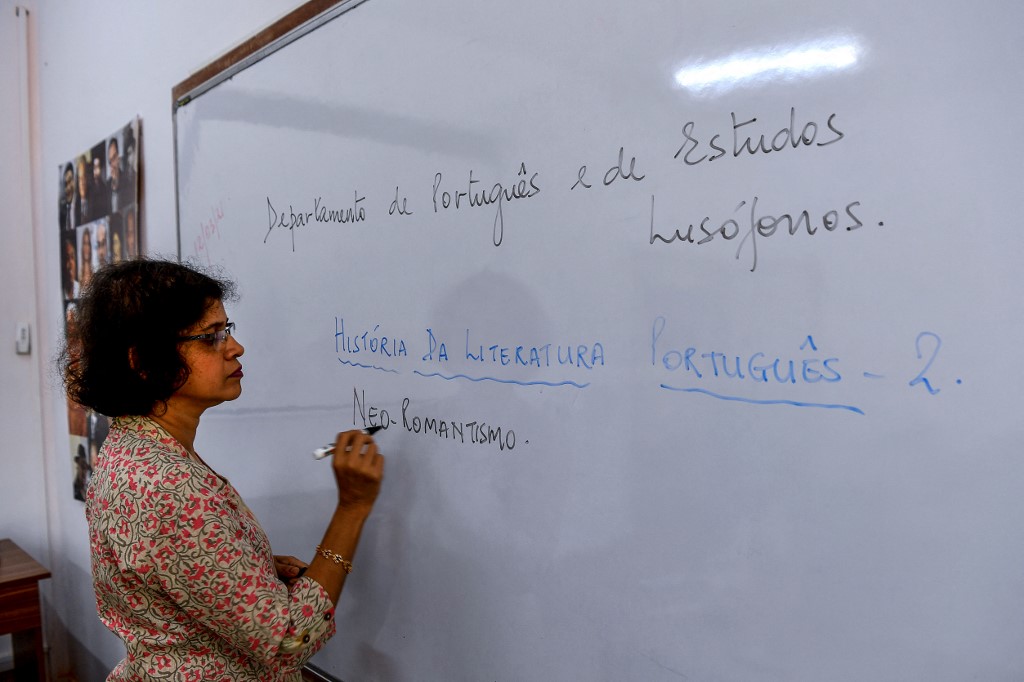 Lorraine Alberto, professor of Portuguese language at Goa University, writes on a whiteboard as she leads an online class at Panaji in Goa on March 12. – AFP pic
