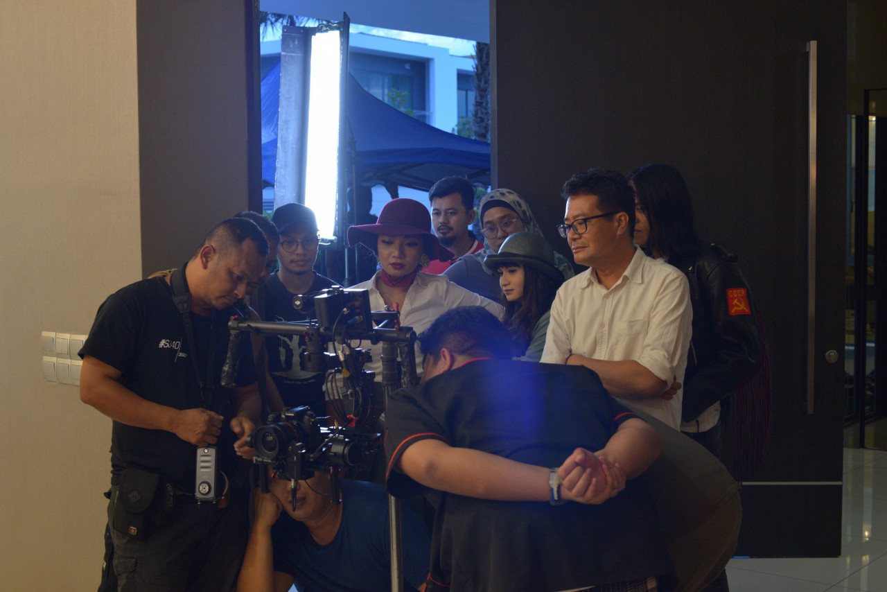 The cast and crew in action, with director Al Jafree Yusop (in white, right) looking on. – Pic courtesy of Mubi