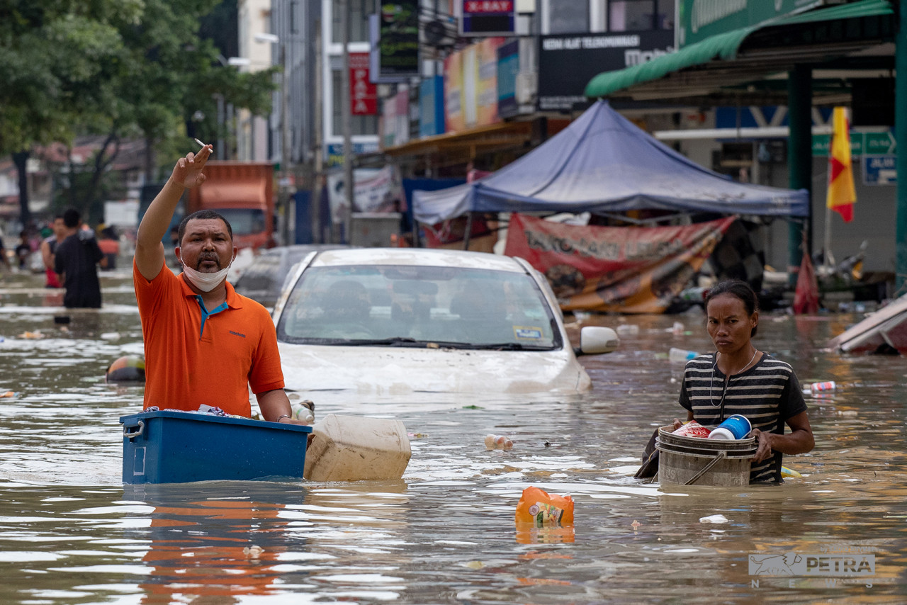 People wading through muddy, dirty and dangerous floodwaters to access food supplies. – SADIQ ASYRAF/The Vibes pic, December 22, 2021
