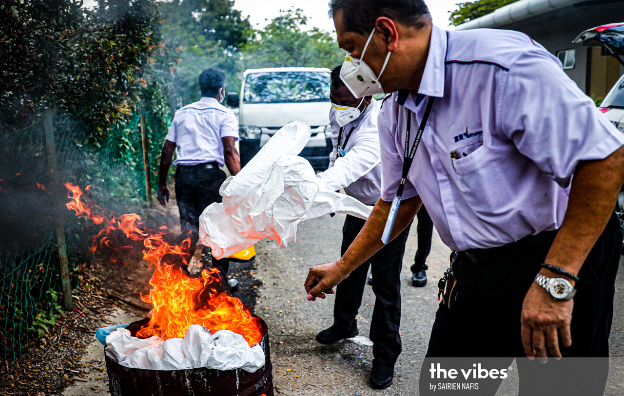 Protective gear worn by health personnel is burned following a funeral at the Nirvana Memorial Park. – The Vibes pic, February 4, 2021