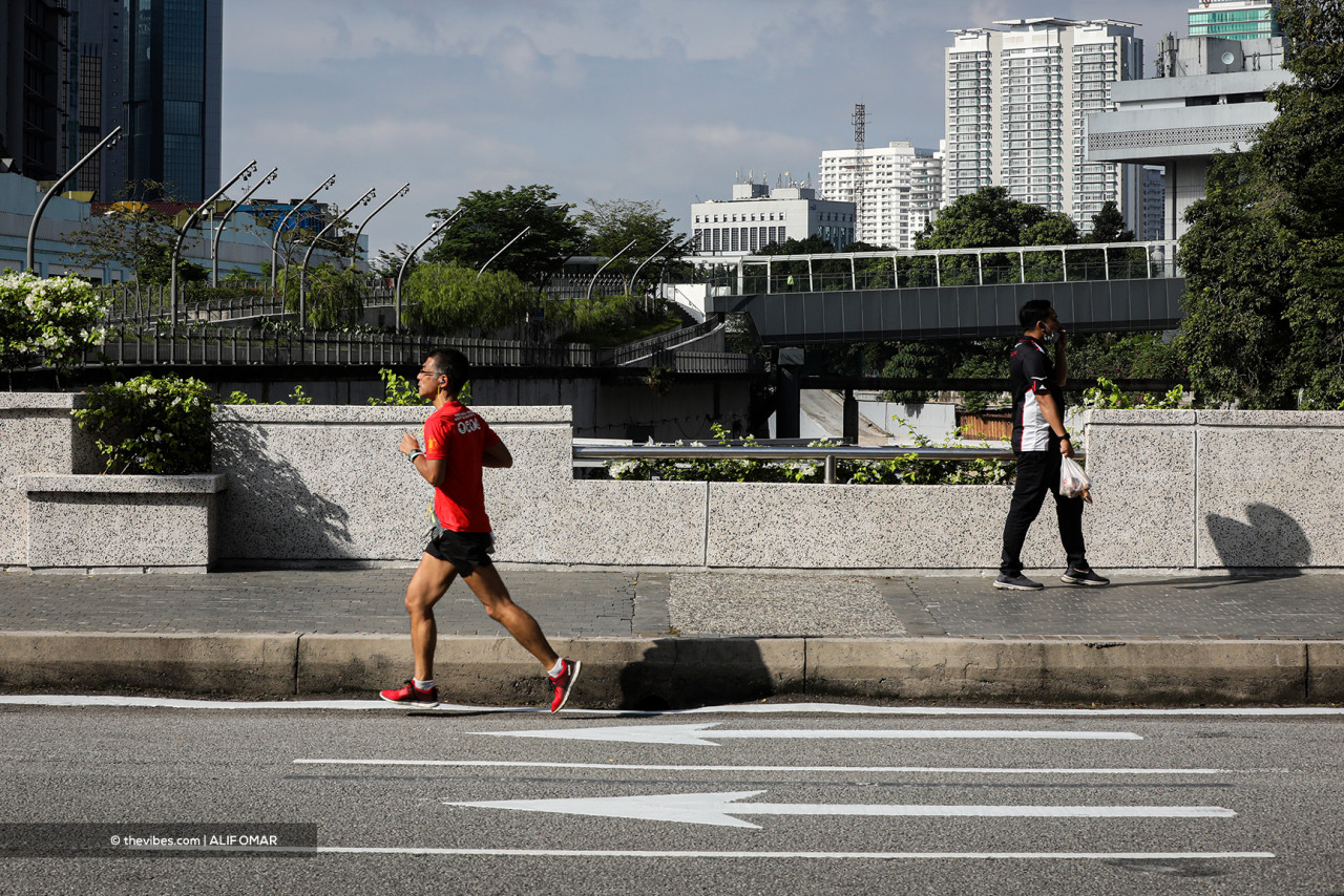 A man jogs in the quiet, almost carless streets of Kuala Lumpur. – ALIF OMAR/The Vibes pic, June 1, 2021