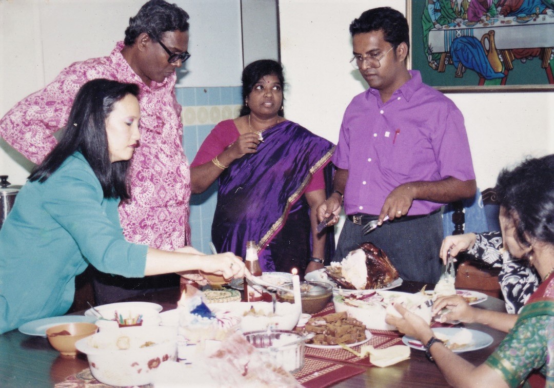 Preparing a Christmas Eve dinner in the absence of Joe Sr. Sibling Noel in purple shirt takes over Father’s fond task of preparing and carving the festive turkey. – Pic courtesy of Masilamany family album