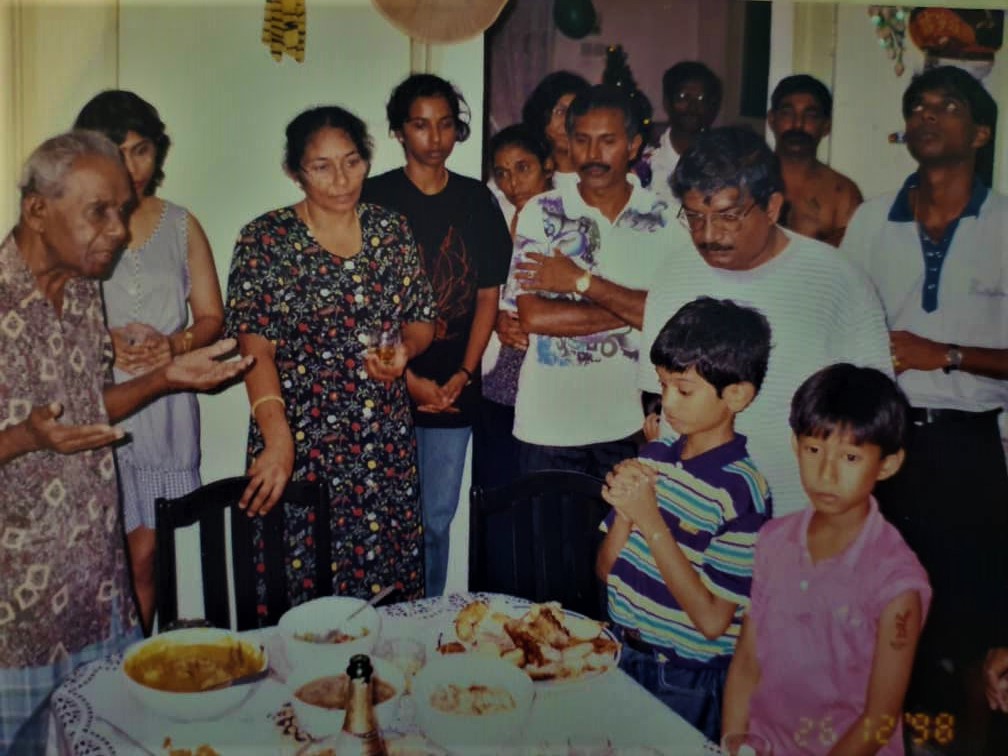 Another small Masilamany family gathering. Joe Sr (left) prays the grace before meals. – Pic courtesy of Masilamany family album