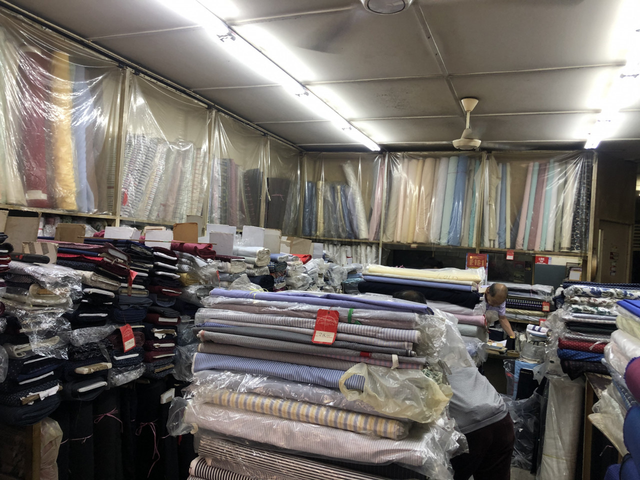 Textiles are piled from floor to ceiling in every corner of the shop. - Pic by Tai Xuan