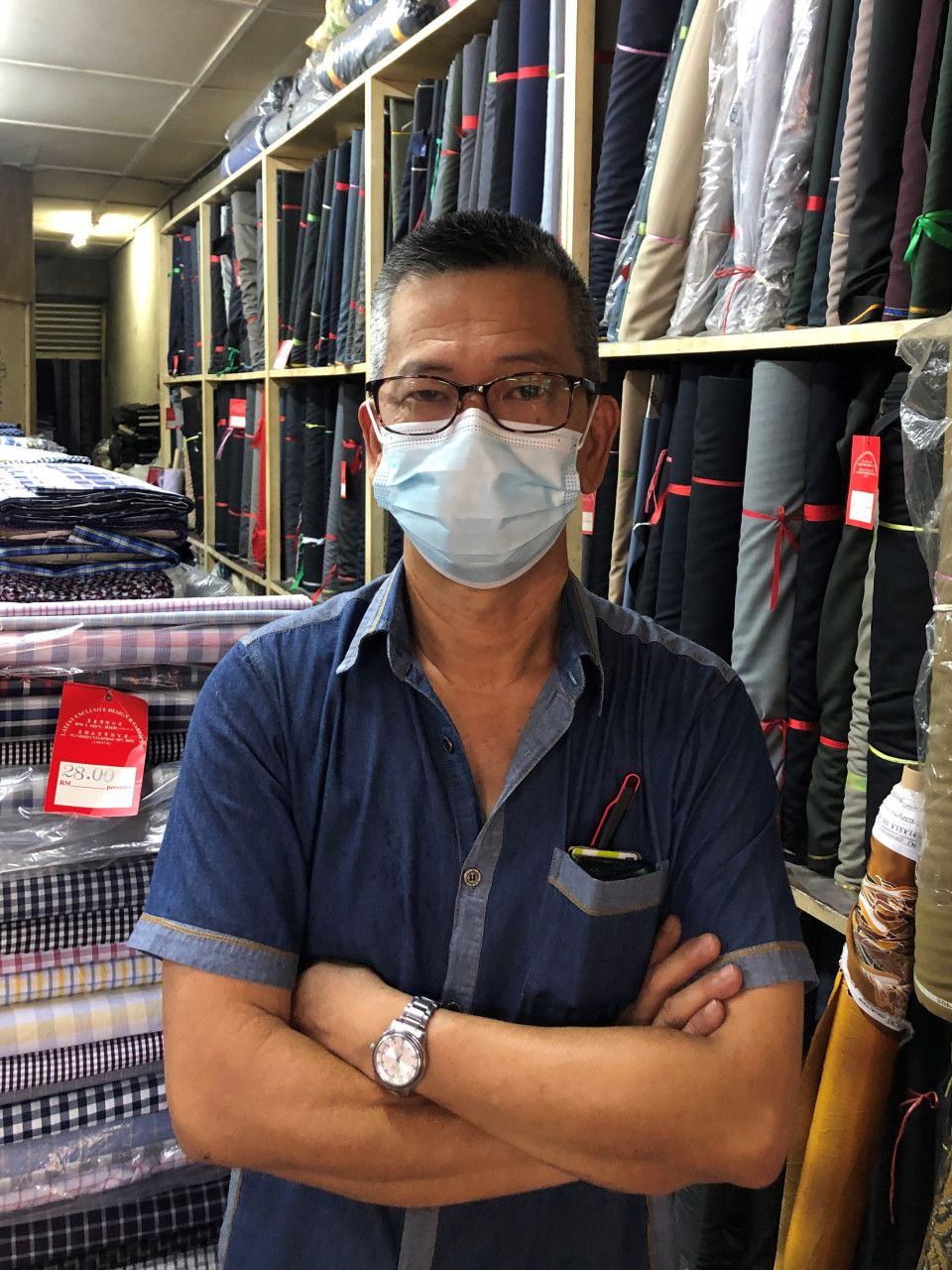 The second-generation owner of Ban Wah Textile, Steven Lee, proudly posing with his products. - Pic by Tai Xuan