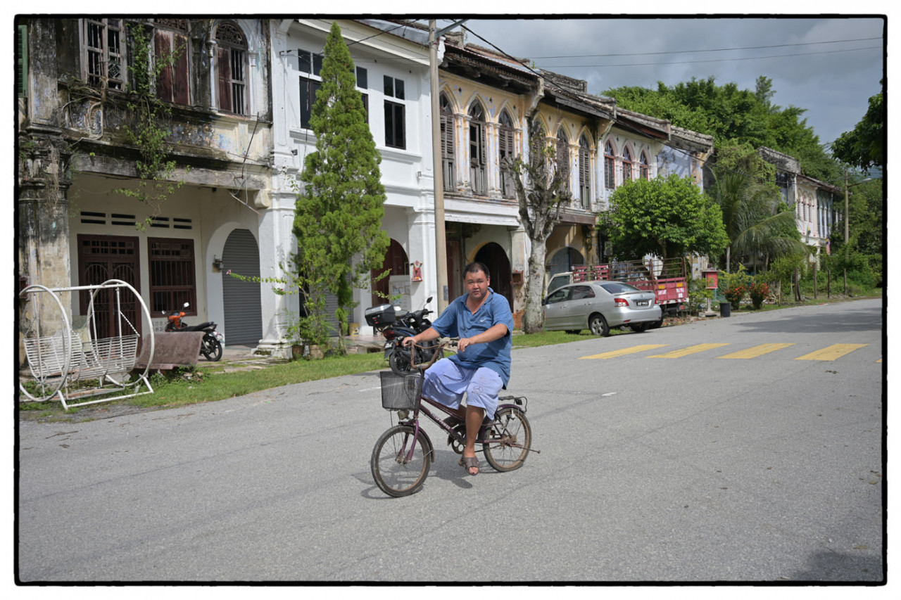 The quiet life. A man seen cycling in front of ‘straits eclectic’ design shophouses. – Pic courtesy of Philippe Durant