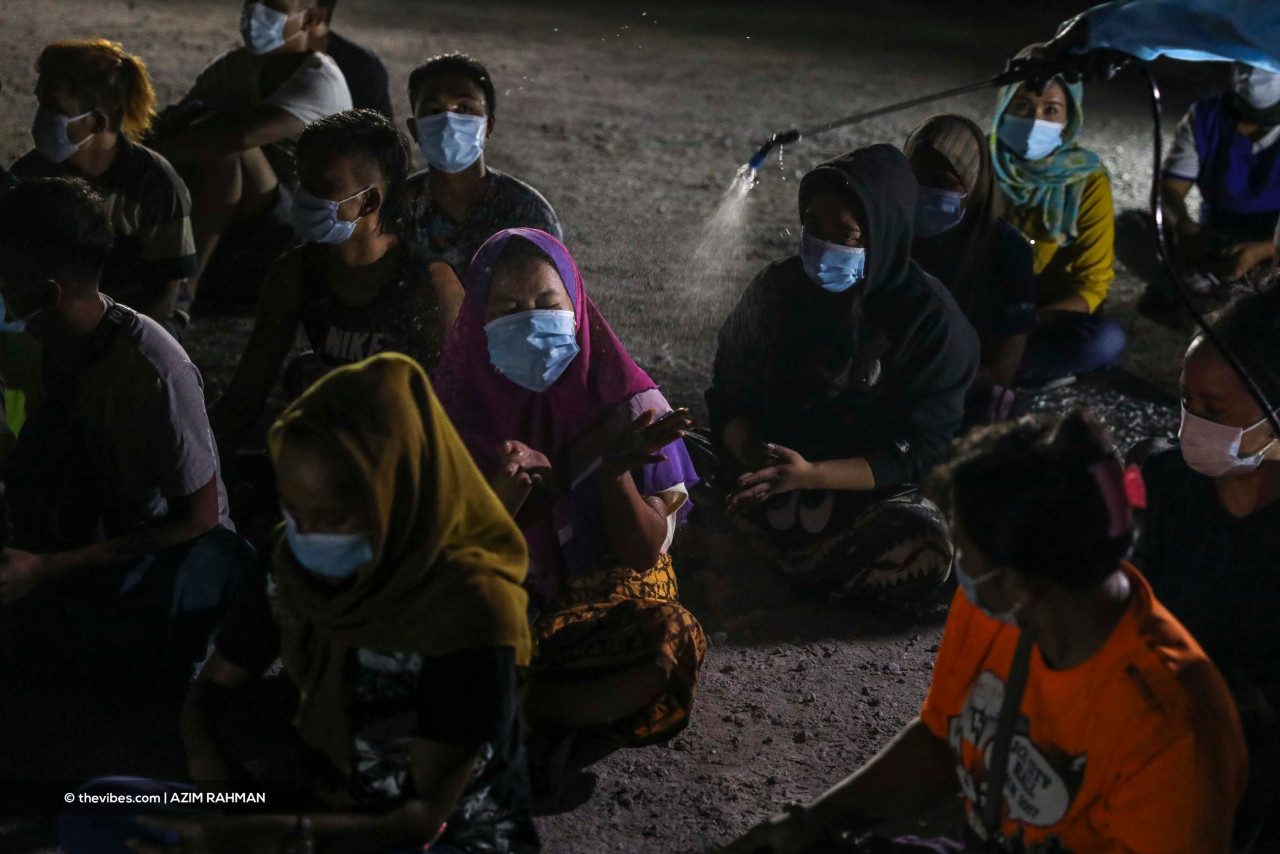 Those detained during the raid were sanitised to prevent the spread of Covid-19. – AZIM RAHMAN/The Vibes pic, June 7, 2021