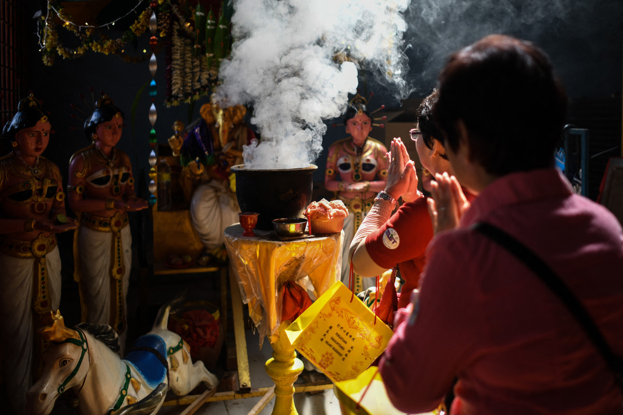 Two Buddhist devotees pray during a prayer procession during Wesak Day back in 2019 at the Enlightened Heart Tibetan Buddhist temple in Ipoh. – AFP pic