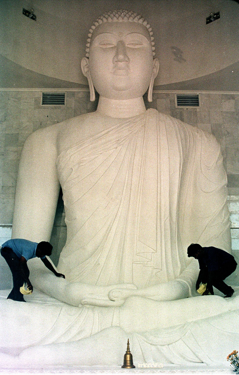 Workers clean a statue of the Buddha at a Sri Lankan Buddhist temple two days ahead of the religious Wesak day celebration in Kuala Lumpur on May 19, 1997. The 26-foot high marble statue of the indoor seated Buddha was newly completed at the time. – AFP pic