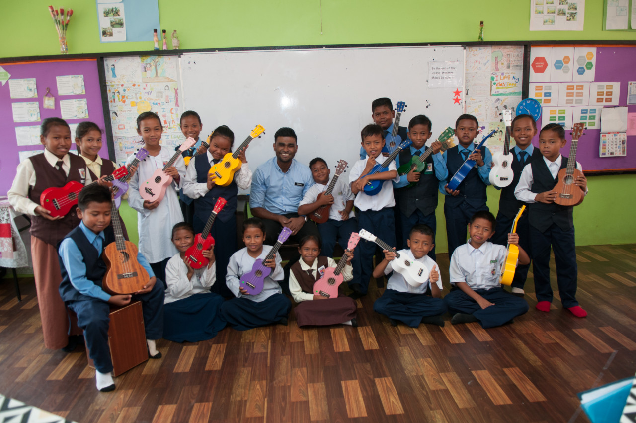 Samuel engaging his students with an ukelele. – PIc courtesy of Samuel Isaiah