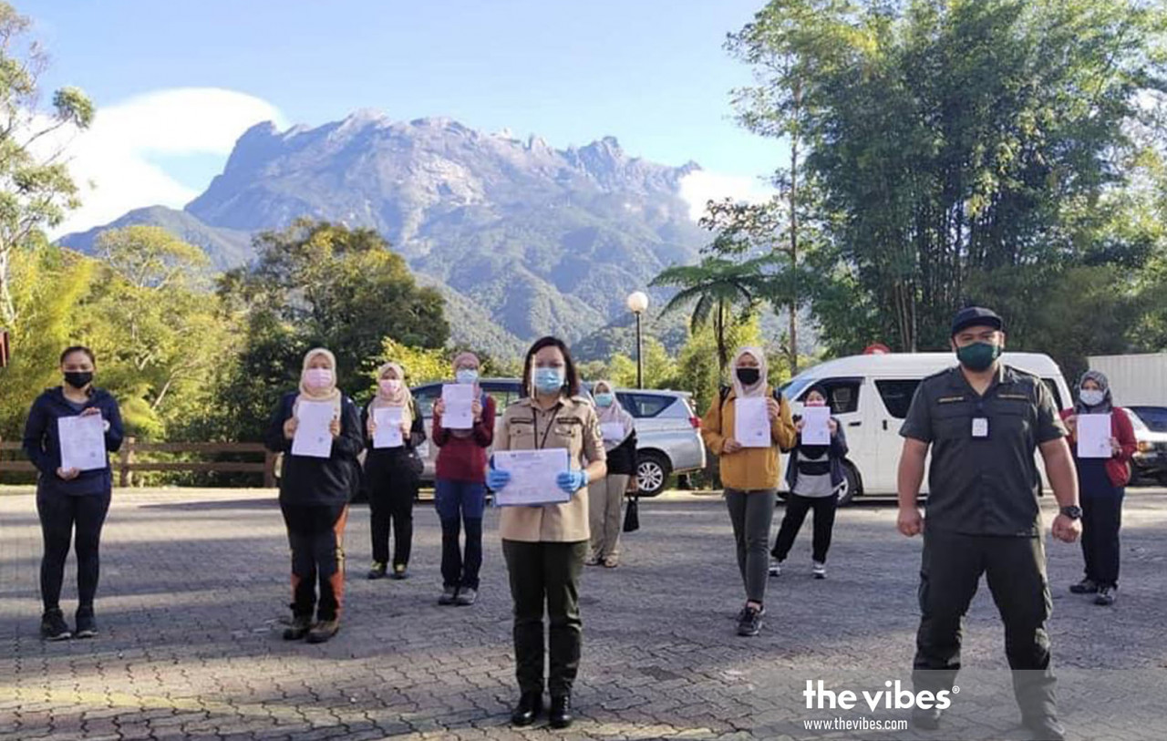 Sabah Parks staff taking a group photo after registering Mount Kinabalu climbers this morning. – The Vibes pic, March 5, 2021