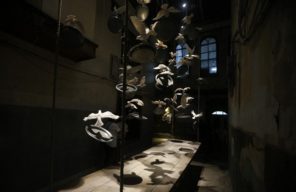 An art installation using ceramic caged doves is pictured in an alley in old Damascus, as part of an exhibition titled 'Once Upon a Time… Windows', in the Syrian capital, on April 8. – AFP pic