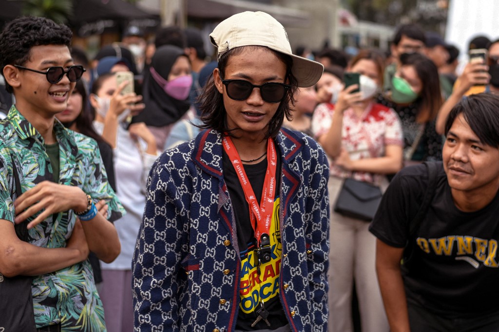 This picture taken on July 22, 2022 shows a TikTok celebrity Bonge (C) joining Indonesian youths as they meet by a pedestrian crossing turned catwalk, part of a self-styled fashion gathering in recent weeks dubbed Citayam Fashion Week, in Jakarta. – AFP pic
