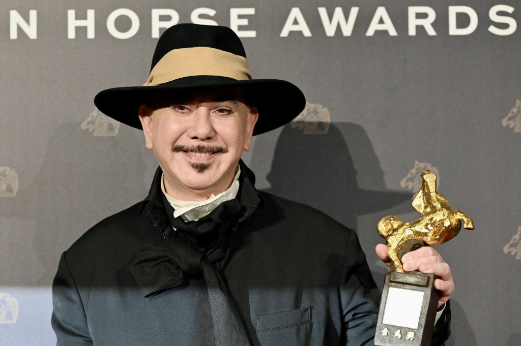Anthony Wong poses for pictures after winning the Best Leading Actor for 'The Sunny Side of the Street' at the 59th Golden Horse Film Awards. – AFP pic