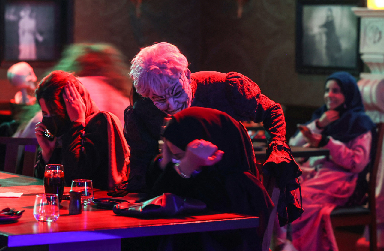 Actors in zombie costumes liven up the atmosphere at the horror-themed 'Shadows' restaurant. – AFP pic