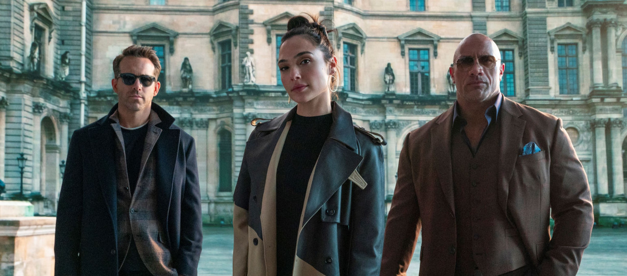 From left: Nolan Booth (Ryan Reynolds), The Bishop (Gal Gadot), and John Hartley (Dwayne Johnson). – Pic courtesy of Netflix
