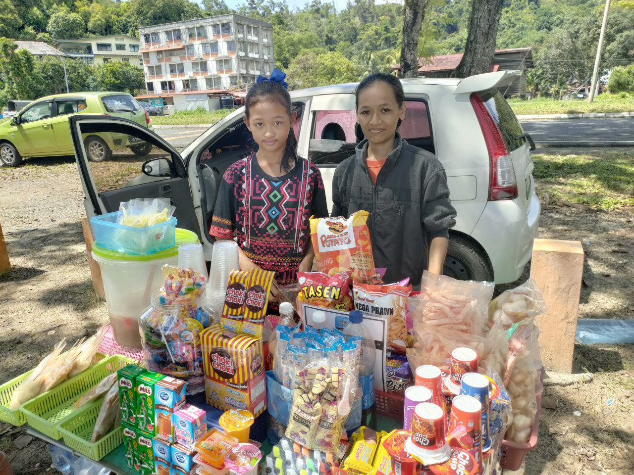Emma (right) has been selling snacks at Pasir Putih beach since 2005. She says hawkers clean up the area surrounding the stalls before leaving for the day. – REBECCA CHONG/The Vibes pic, November 6, 2021