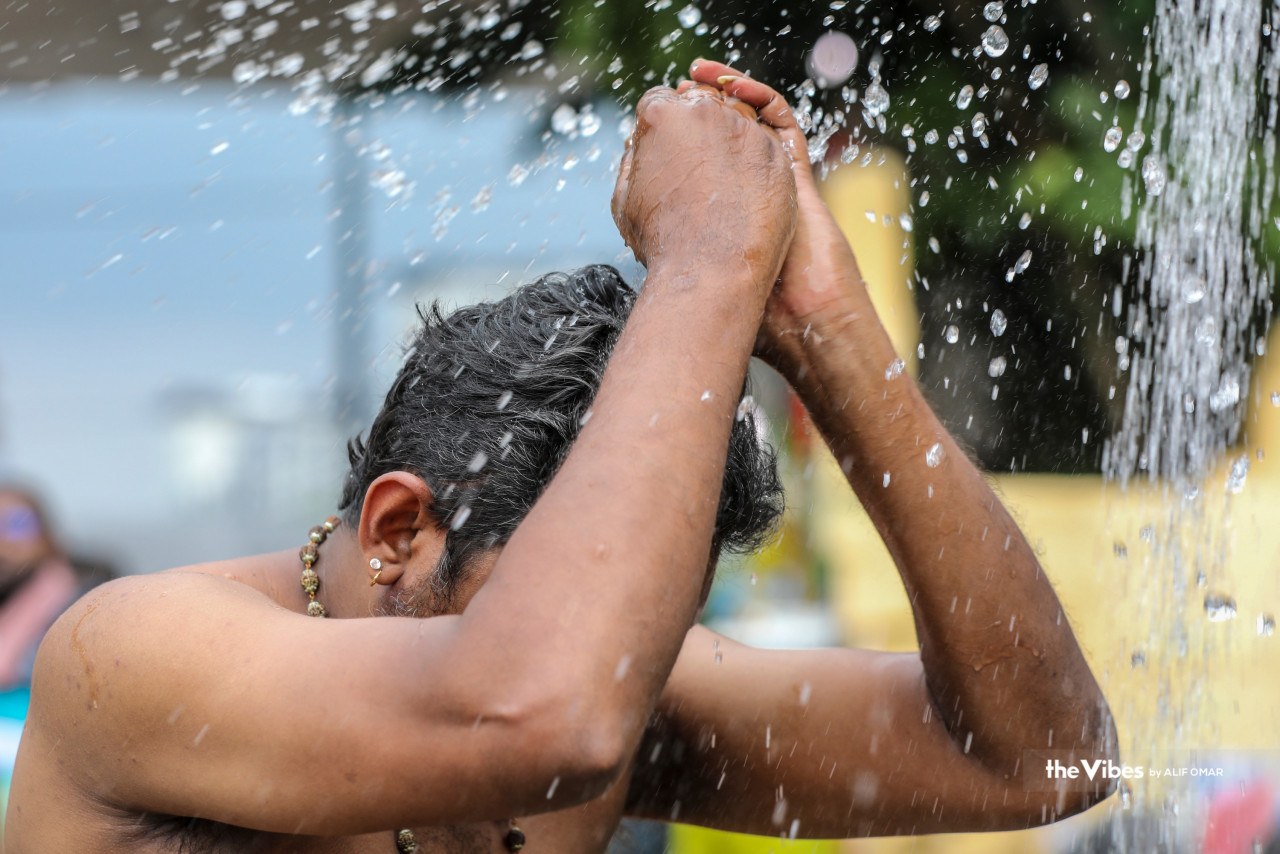 A devotee cleanses himself before carrying out Thaipusam rituals. – Alif Omar/The Vibes pic
