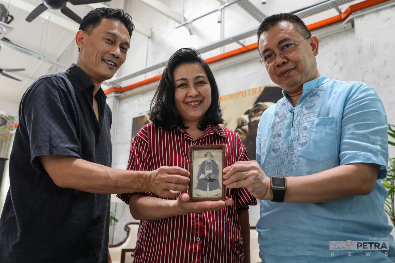 Glenn (L) Wai Ming (R) and Grace Yap Sook Ping - fifth-generation descendants of Kapitan Yap Ah Loy holding a framed picture of their great-great-grandfather. – ALIF OMAR/Vibes pic
