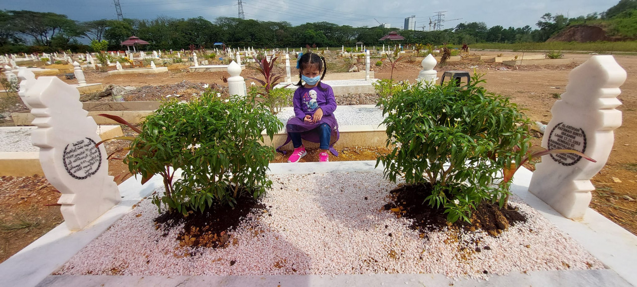 A family member visits the Emak's grave. – Pic courtesy of Abdul Razak Nordin