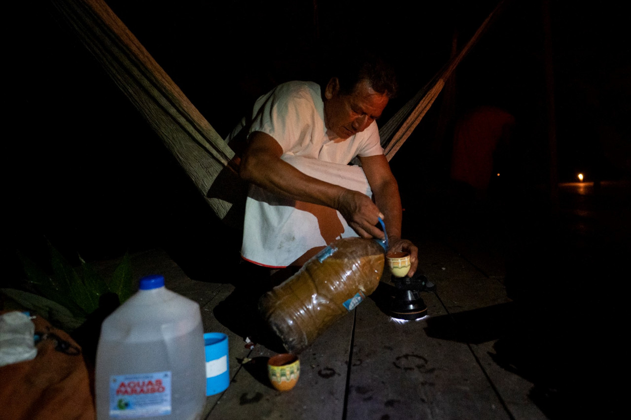 Miguel Payaguaje, healer of the indigenous Siekopai ethnic group (Multicoloured people), pours Yage (Ayahuasca) during a drinking ceremony in Lagartococha, Mañoco, Amazon region, Peru, on January 11. – AFP pic