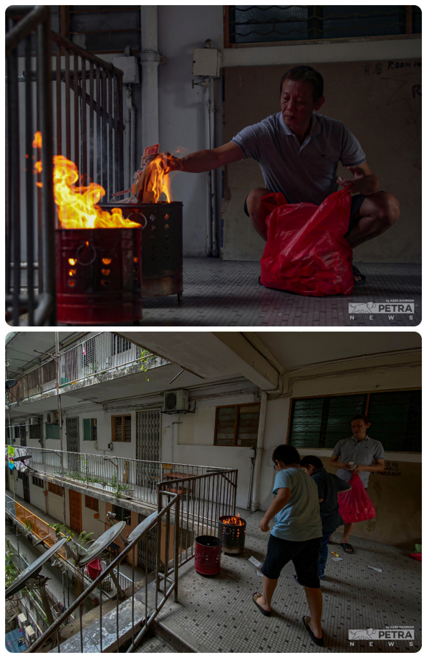 Swee Huat can be seen burning prayer offerings, as his boys join in on the ritual. — The Vibes/Azim Rahman pic