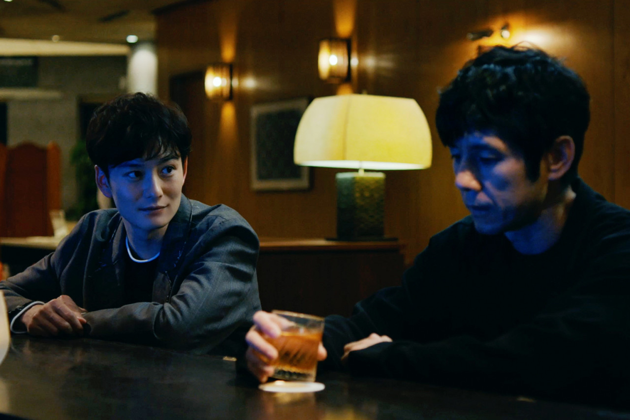 Yusuke (L) has a drink with one of his actors, Koshi Takatsuki (Masaki Okada), with whom he shares a dark secret with. – Pic courtesy of MUBI