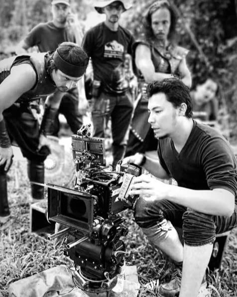 Adi Putra, Yayan Ruhian and some crew look over as director Syamsul Yusof gives direction. – Pic taken from IMDB