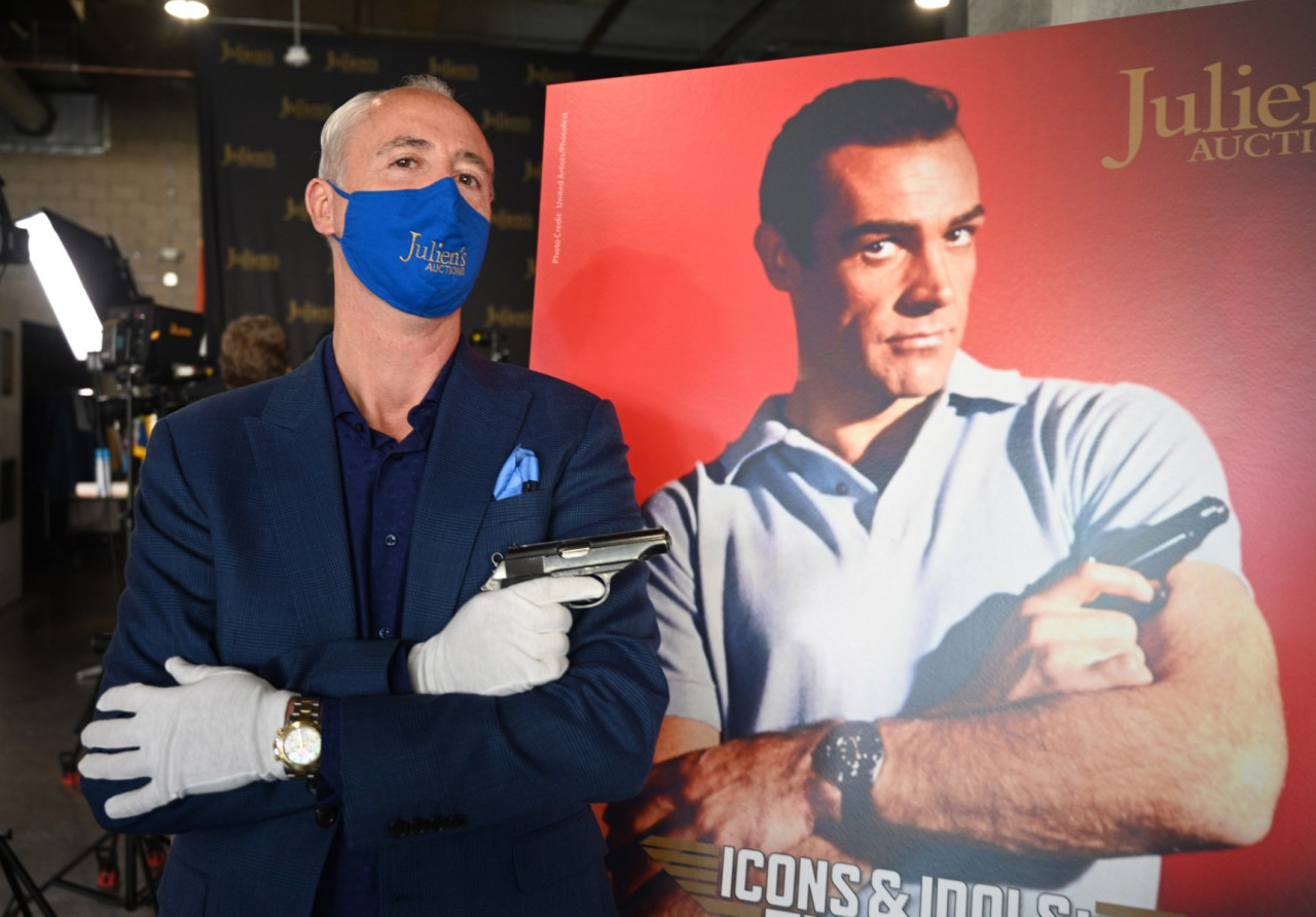 Martin Nolan, executive director of Julien's Auctions, displays the Walther PP handgun used by Sean Connery in the first James Bond film, ‘Dr. No’ (1962) at a press preview of Julien's Auctions Presents Icons And Idols: Rock 'N' Roll, Hollywood and Sports, November 24, 2020 in Beverly Hills, California. - AFP pic