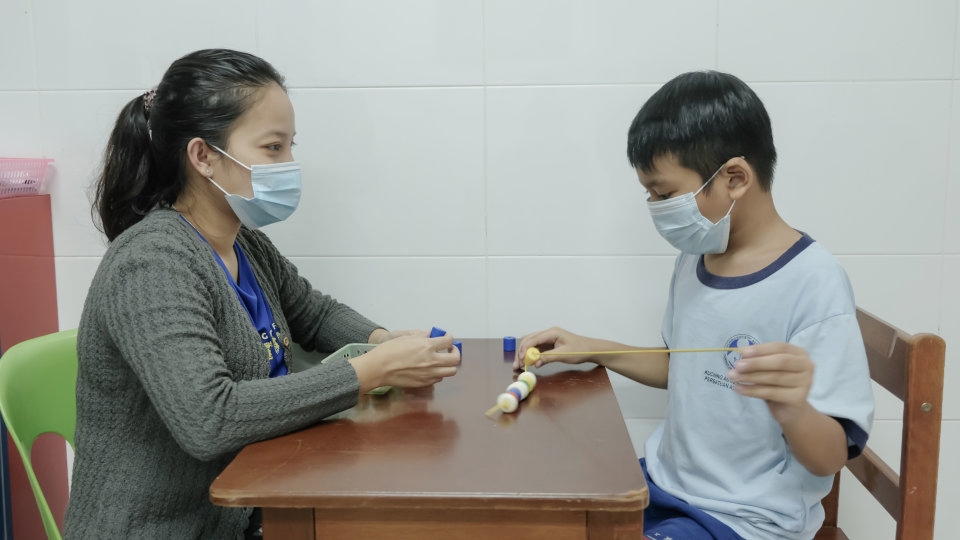 A therapist at the Kuching Autistic Association attends to an autistic child. The symptoms and characteristics of autism present themselves in a wide variety of combinations. - Pic courtesy of Kuching Autistic Association