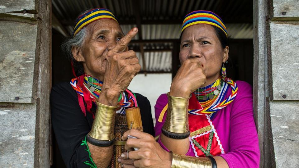 Ring Lady Ayun (L) and Anat decked out in traditional 'ruyang' or forearm bangles, which symbolises the Bidayuh sub-ethnic Bi’embhan culture. – AFP pic