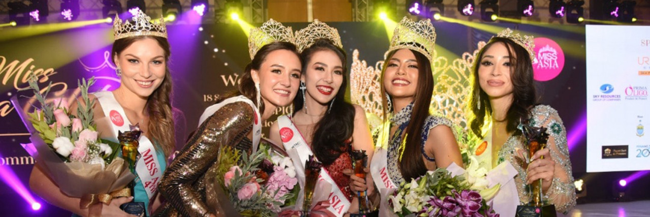 The pageant winners preen in front of the cameras in their moment of triumph. 